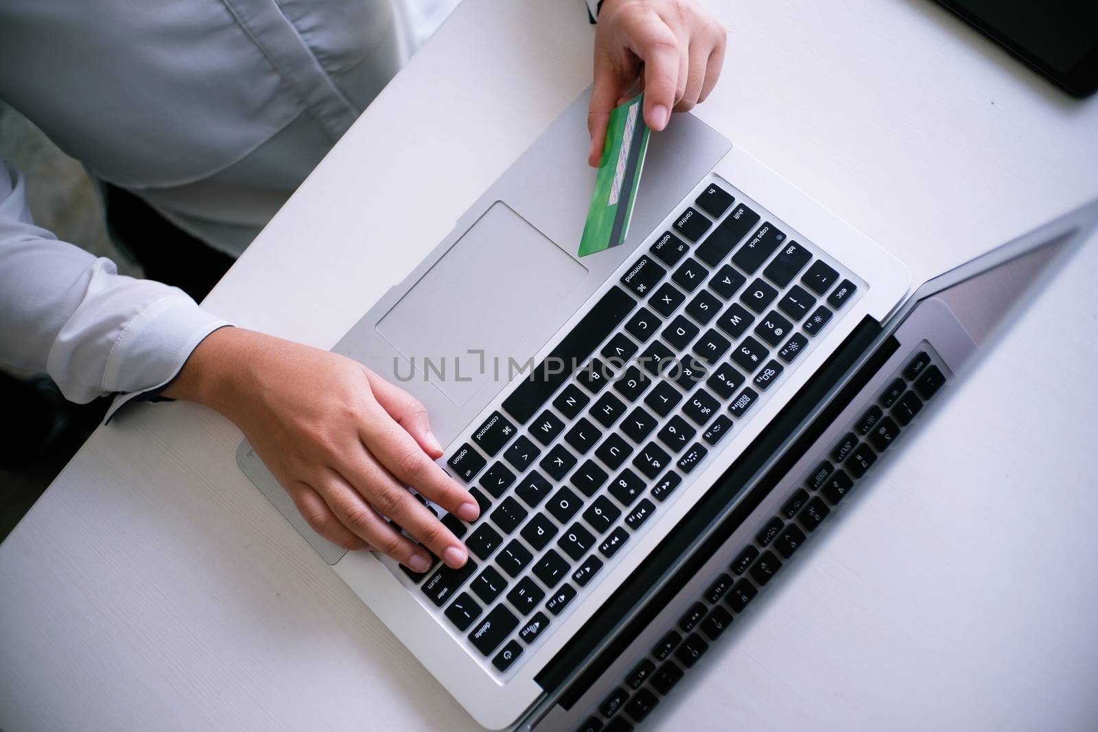 Business Woman Hands holding plastic credit card and using laptop smart phone Online shopping concept