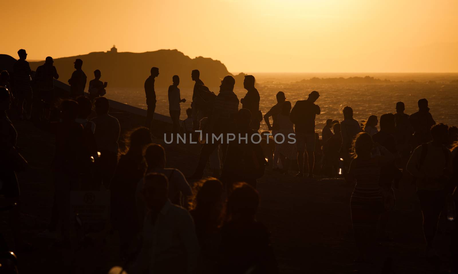 silhouettes of people taking pictures with smartphones and Greek flag
