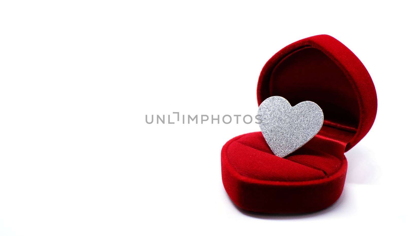  Silver glitter heart in wedding ring box. Valentines day present concept