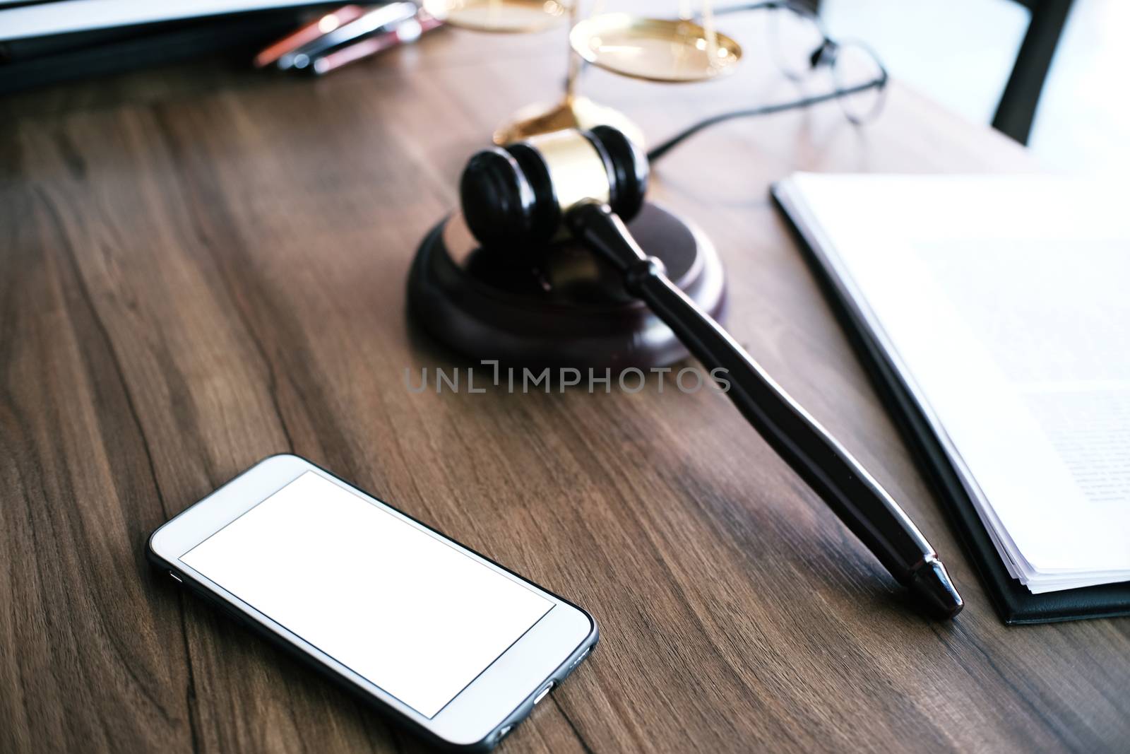 Judge gavel hammer with smartphone on Lawyer desk. by peandben