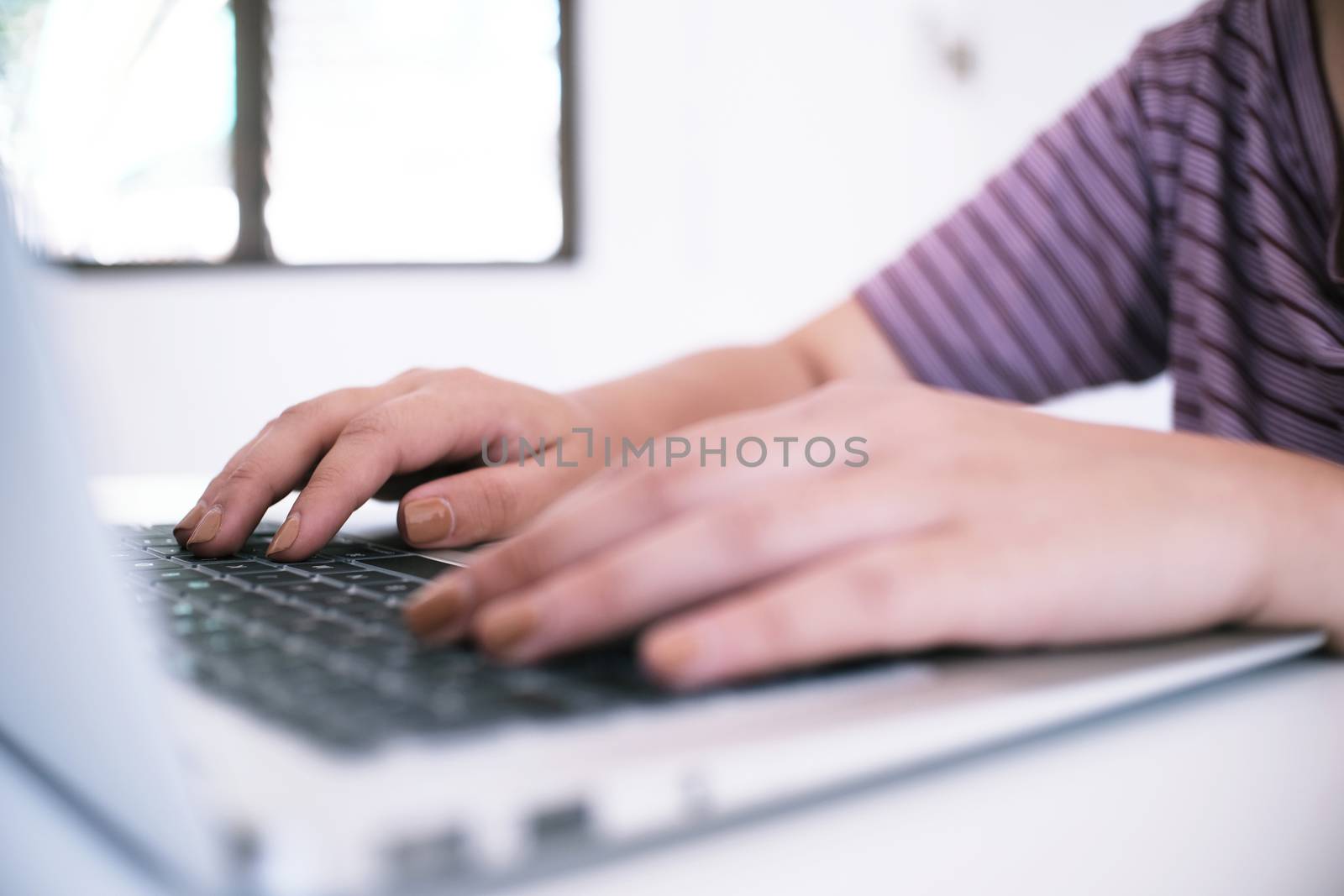 The Casual business woman works online on laptop which hand on k by peandben