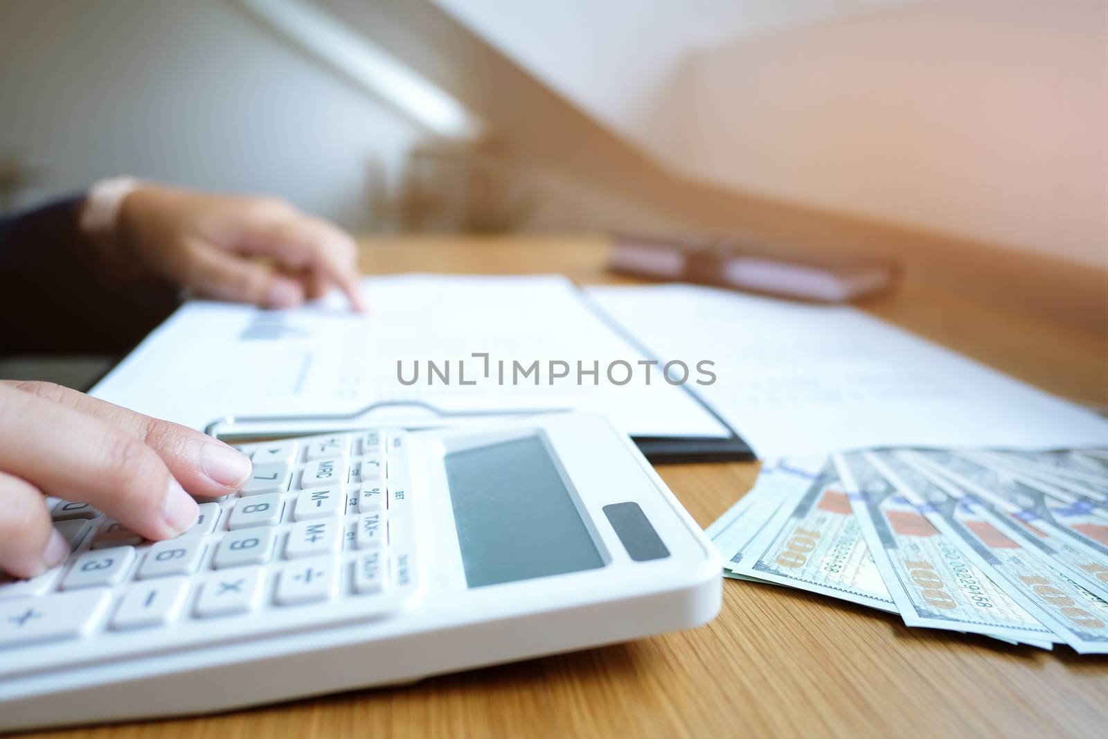 Businessman analyzing investment charts and pressing calculator buttons over documents. Accounting Concept