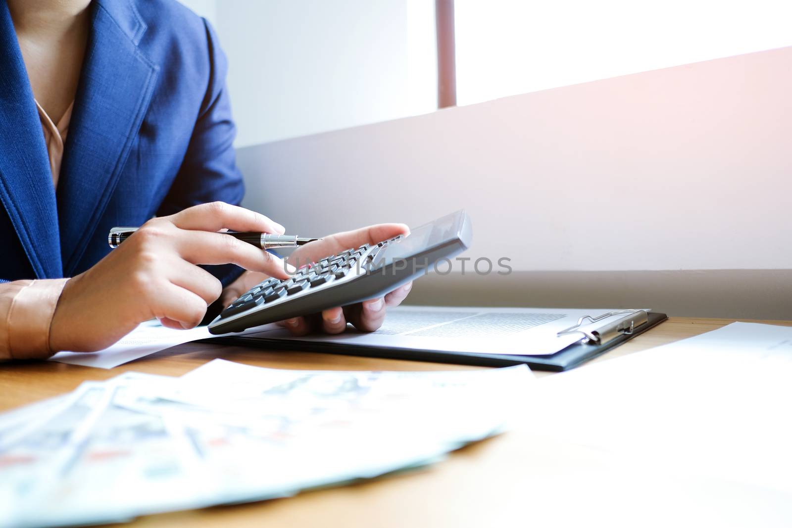 Businessman analyzing investment charts and pressing calculator  by peandben