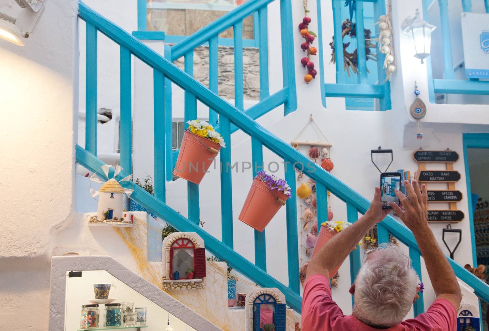 traditional narrow street in Mykonos with blue doors and white walls