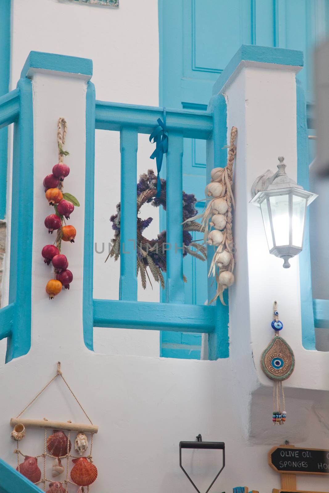 traditional narrow street in Mykonos with blue doors and white walls