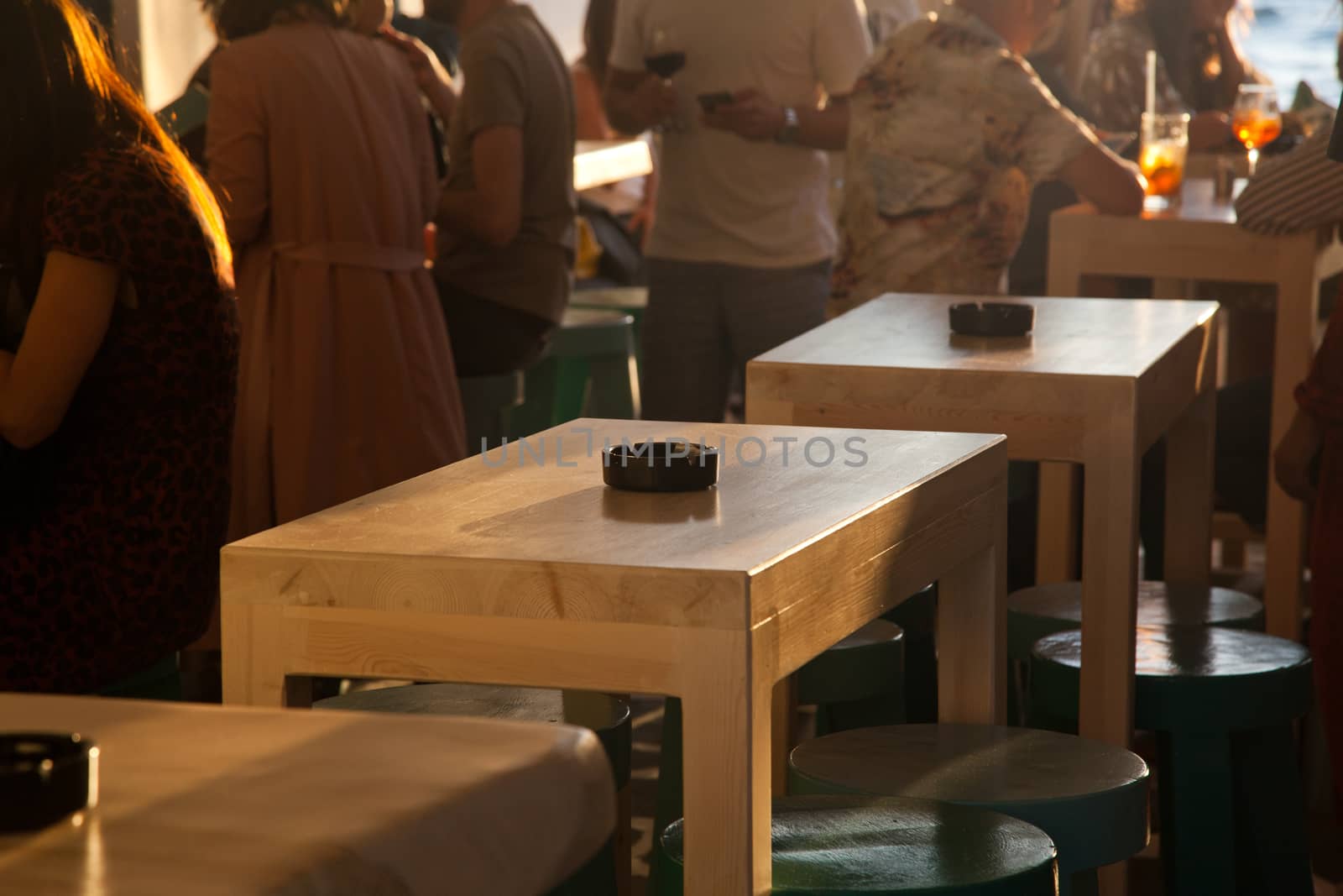 sunset bar by the beach - focus on table by melis