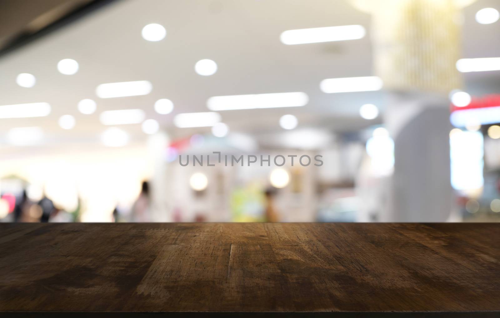 Empty dark wooden table in front of abstract blurred bokeh background of restaurant . can be used for display or montage your products.Mock up for space