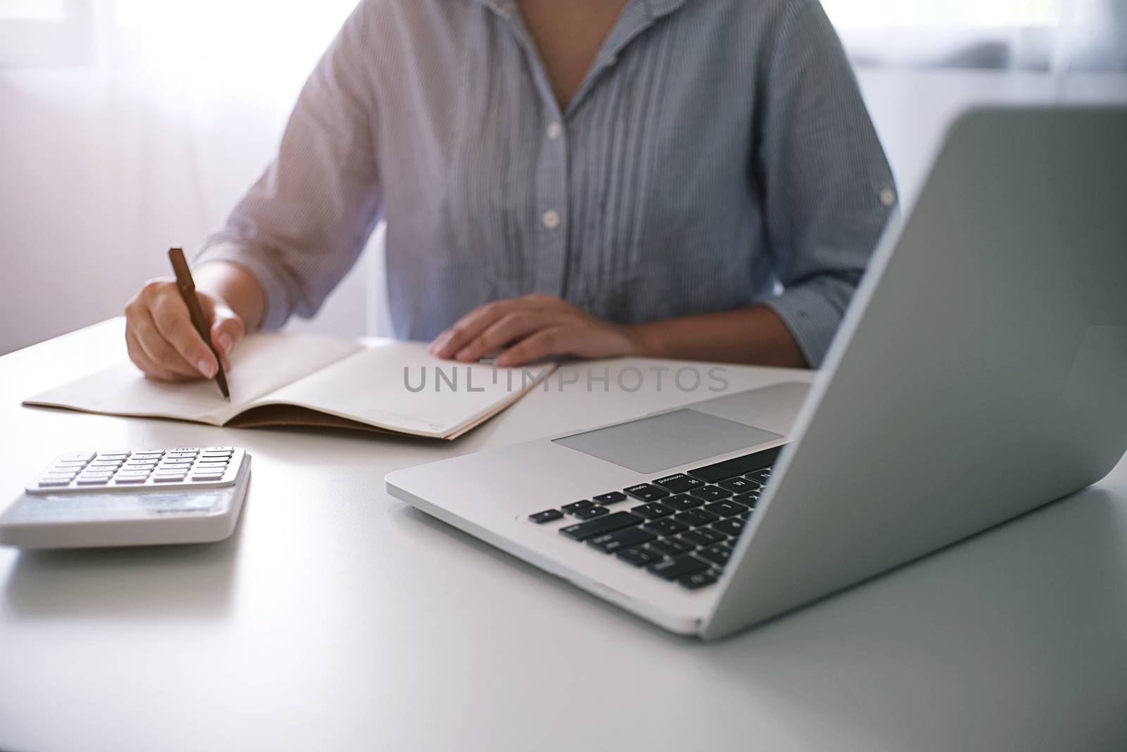 Business accounting women work with calculator and Laptop. Financial technology concept.