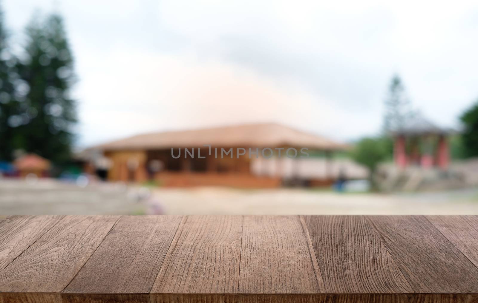 Empty dark wooden table in front of abstract blurred bokeh background of restaurant . can be used for display or montage your products.Mock up for space