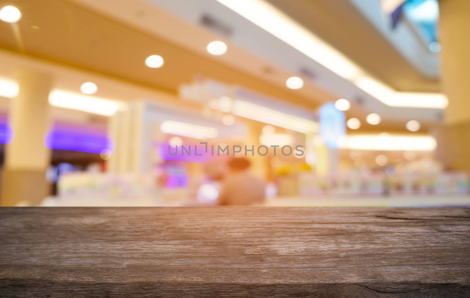 Empty dark wooden table in front of abstract blurred bokeh background of restaurant . can be used for display or montage your products.Mock up for space