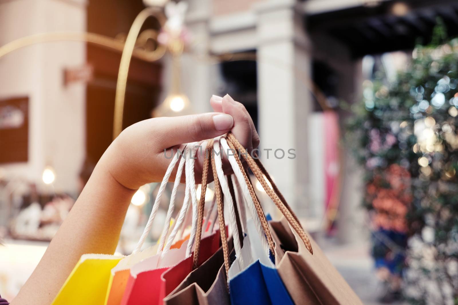 Asian girls holding sale shopping bags. consumerism lifestyle concept in the shopping mall