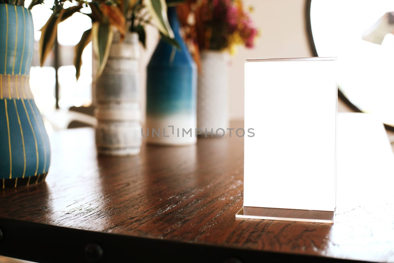 Menu frame standing on wood table in Bar restaurant cafe. space for text marketing promotion