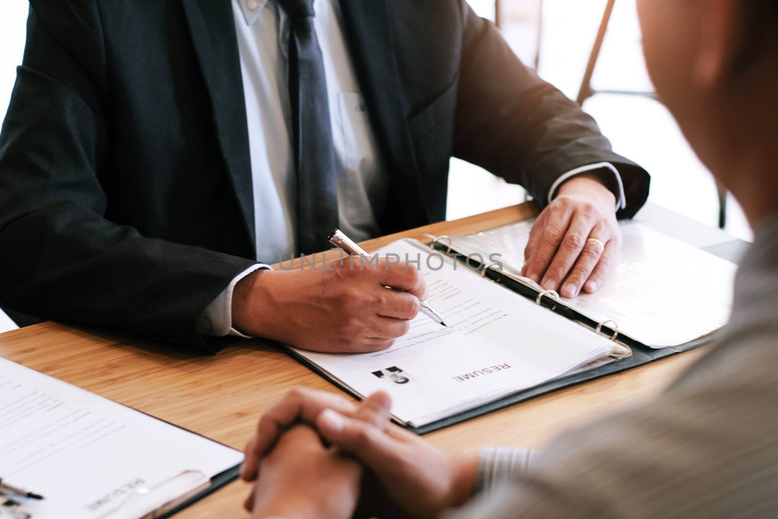 Examiner reading a resume during job interview at office Busines by peandben