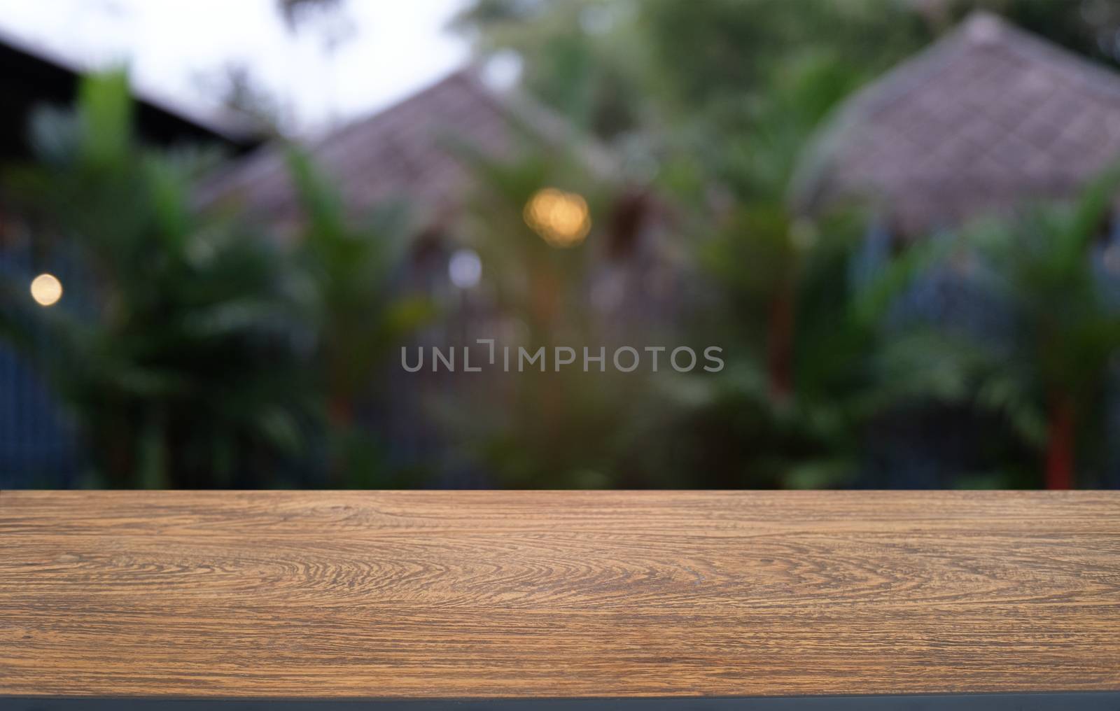 Empty dark wooden table in front of abstract blurred bokeh backg by peandben