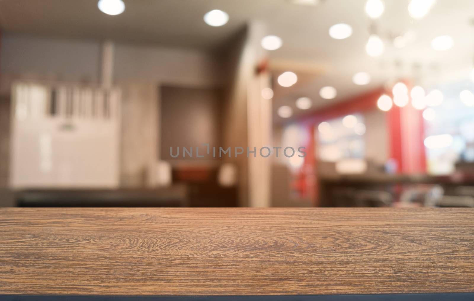 Empty dark wooden table in front of abstract blurred bokeh background of restaurant . can be used for display or montage your products.Mock up for space