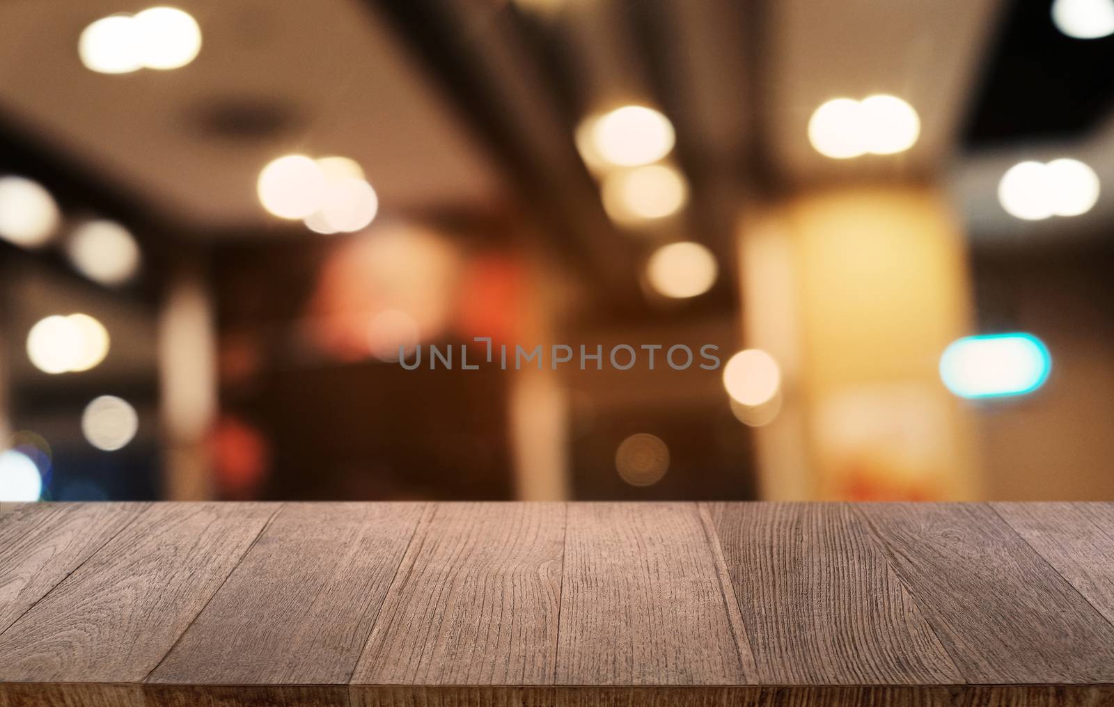 Empty dark wooden table in front of abstract blurred bokeh backg by peandben