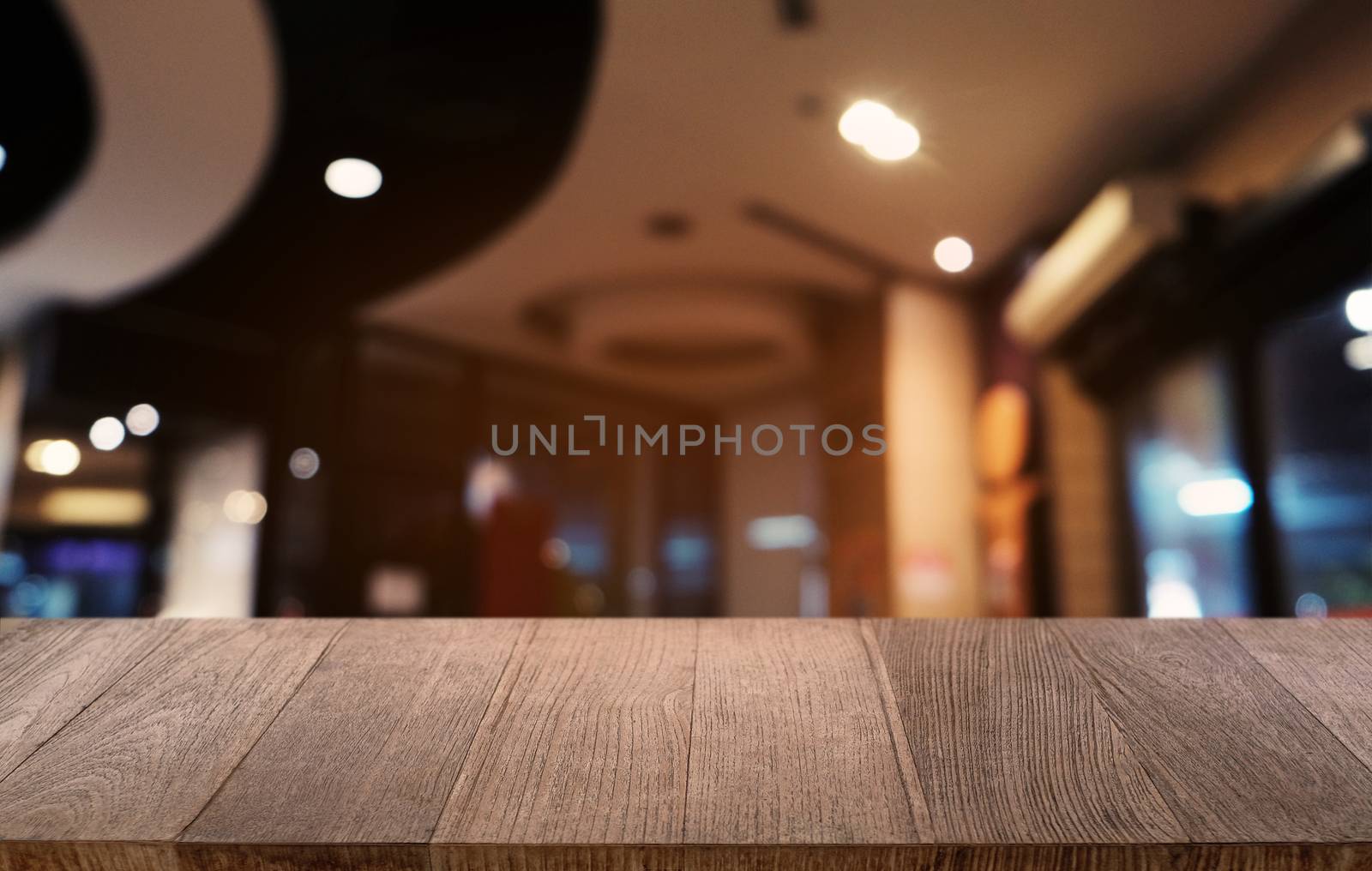 Empty dark wooden table in front of abstract blurred bokeh backg by peandben