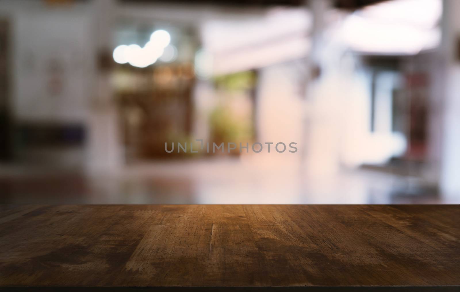 Empty dark wooden table in front of abstract blurred bokeh backg by peandben