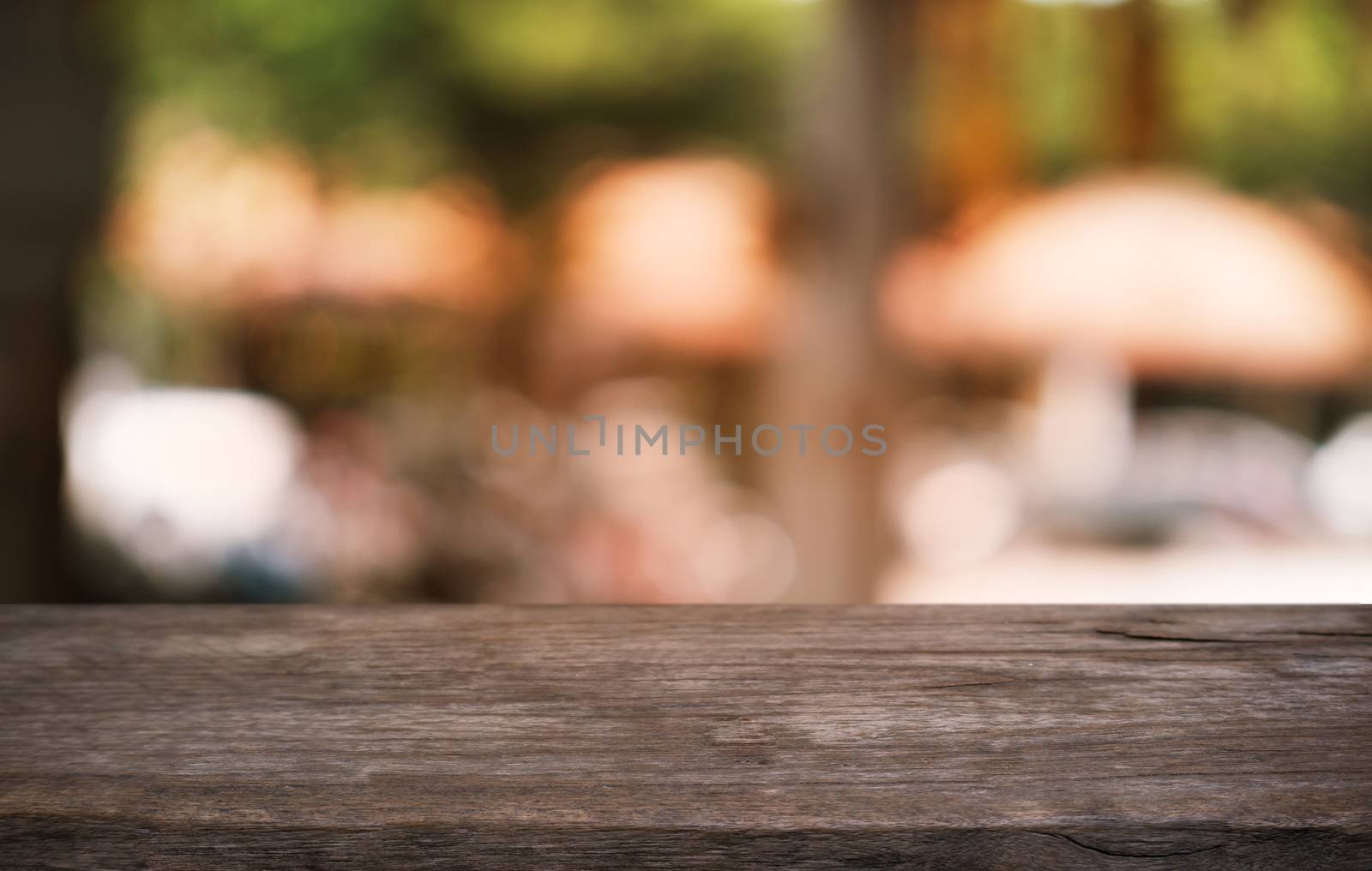 Empty dark wooden table in front of abstract blurred bokeh background of restaurant . can be used for display or montage your products.Mock up for space