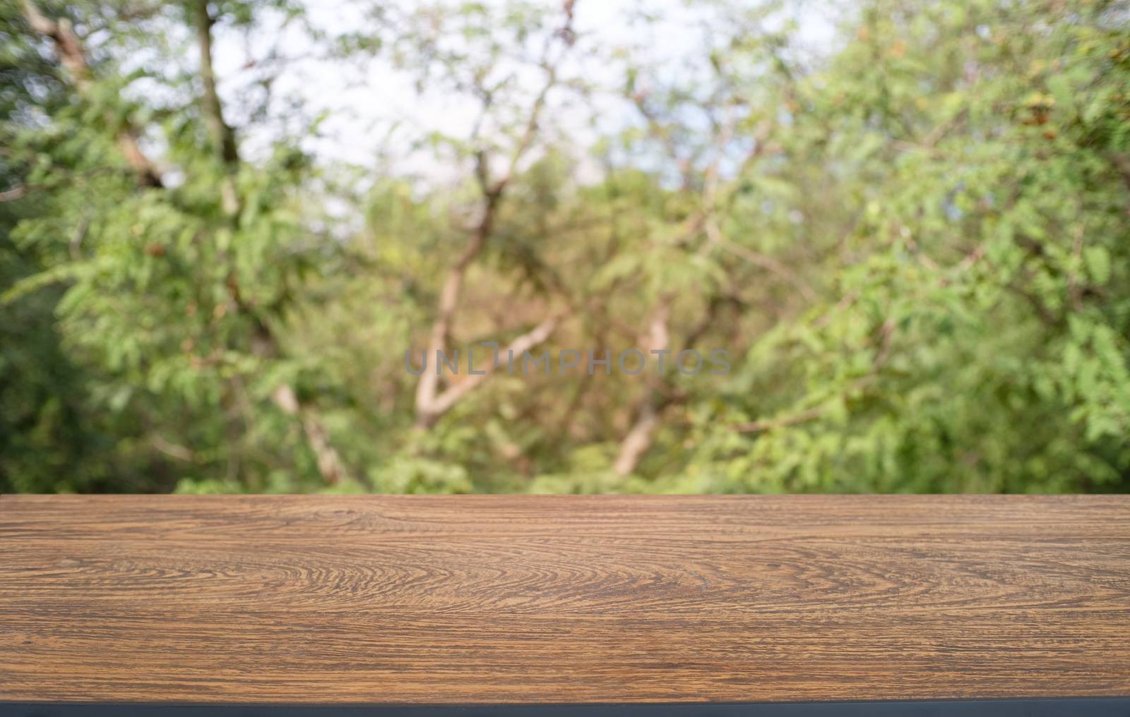 Empty dark wooden table in front of abstract blurred bokeh backg by peandben