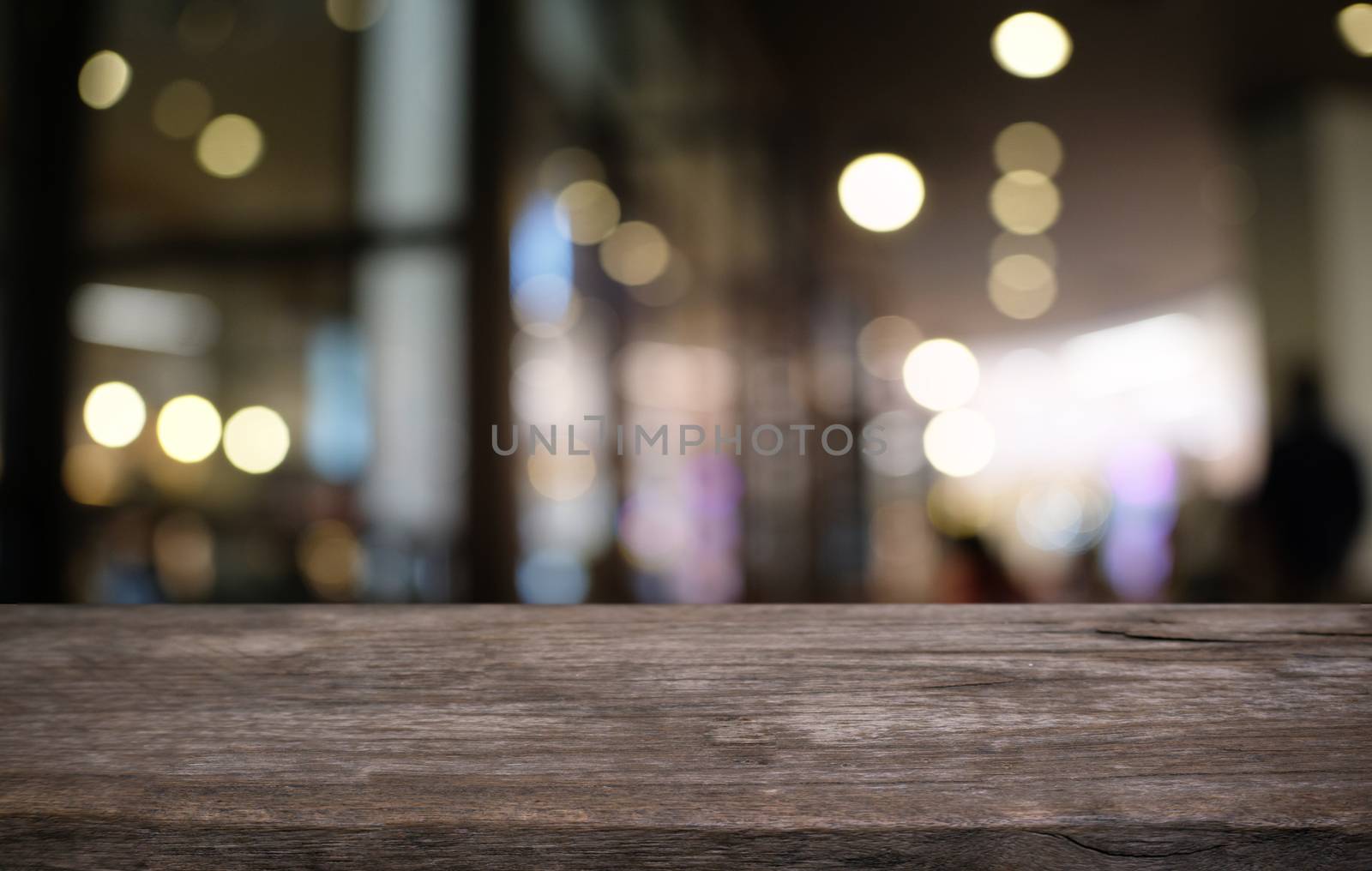 Empty dark wooden table in front of abstract blurred bokeh backg by peandben