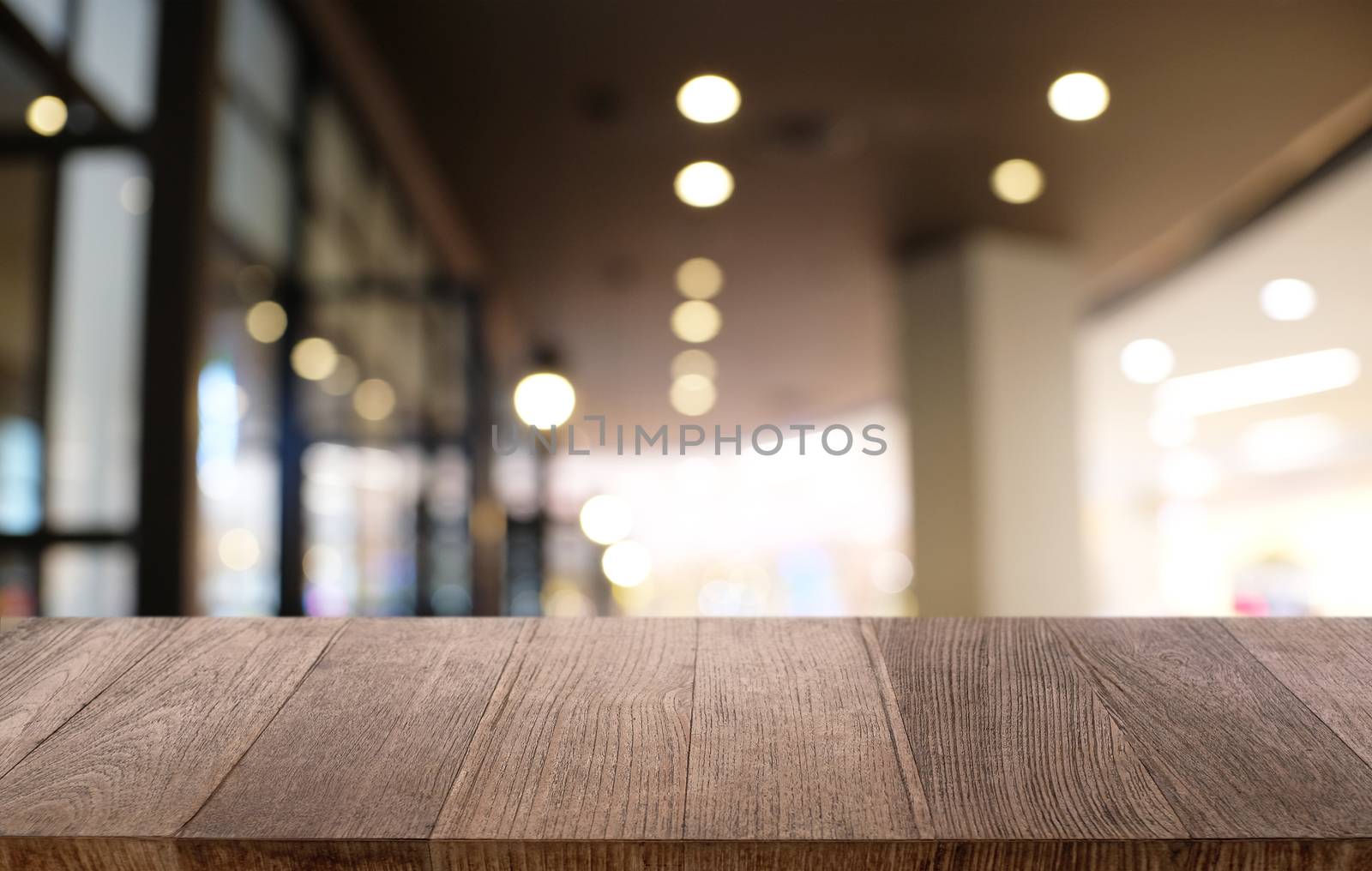 Empty dark wooden table in front of abstract blurred bokeh background of restaurant . can be used for display or montage your products.Mock up for space