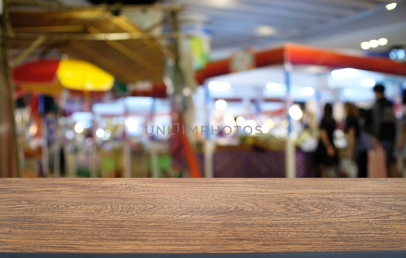 Empty dark wooden table in front of abstract blurred bokeh backg by peandben