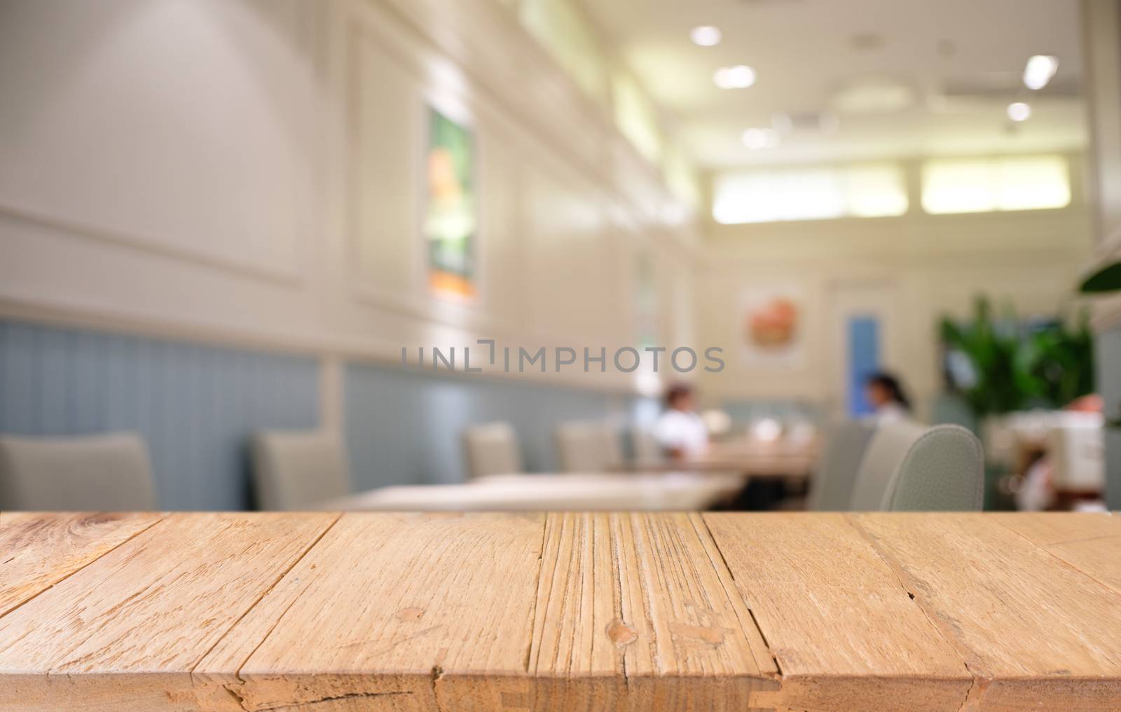 Empty dark wooden table in front of abstract blurred bokeh backg by peandben