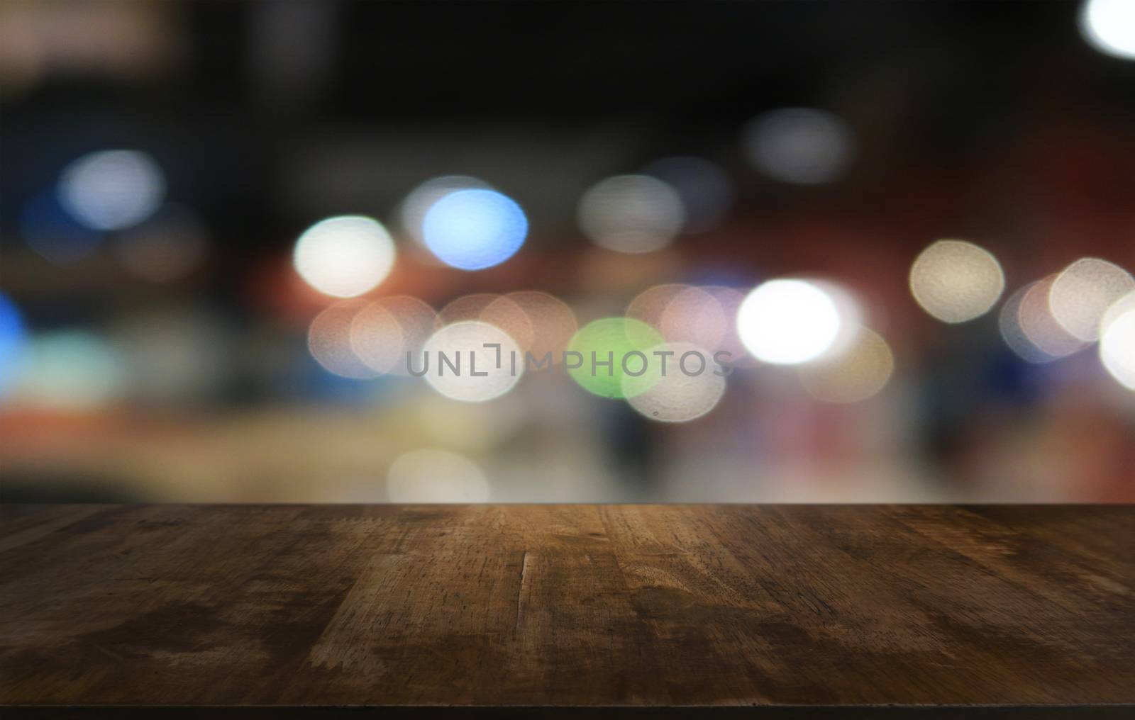 Empty dark wooden table in front of abstract blurred bokeh backg by peandben