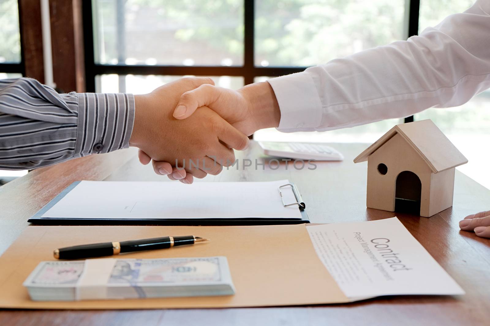 Business people signing contract making a deal with real estate  by peandben