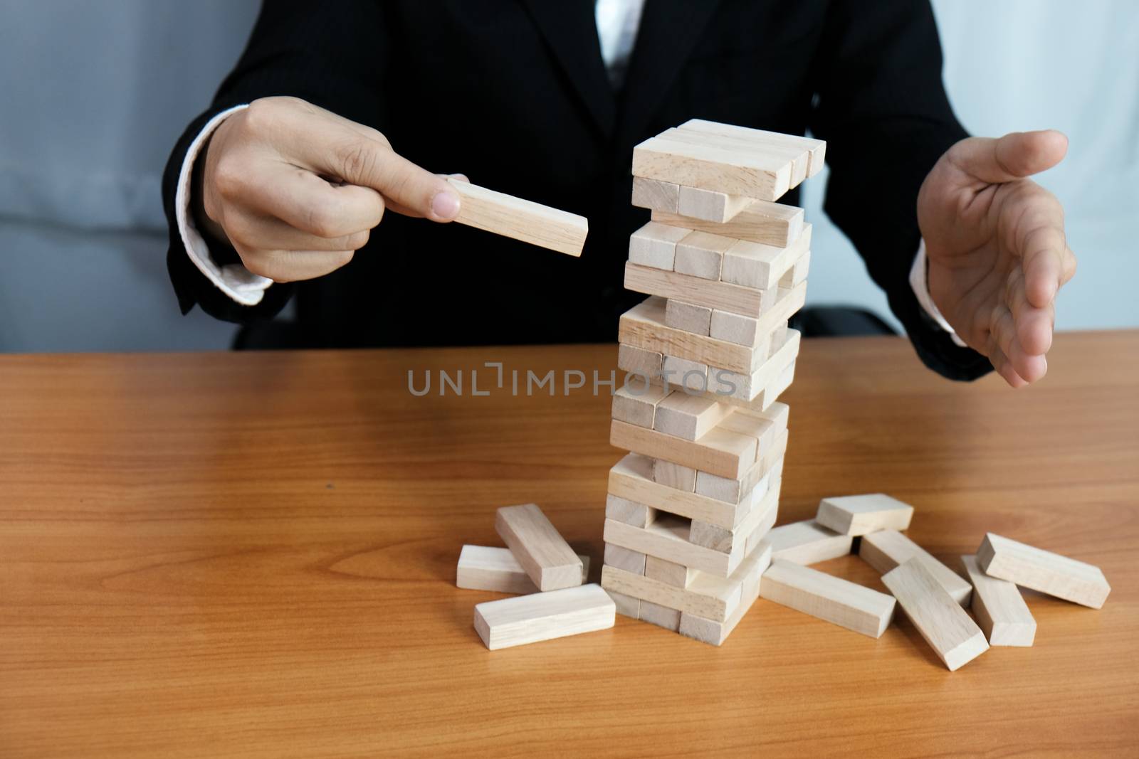 Planning risk and strategy in businessman gambling placing wooden block.Business concept for growth success process.