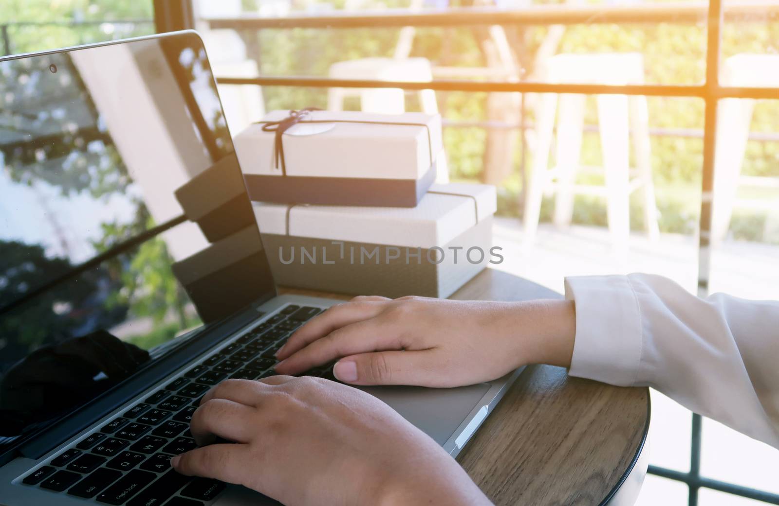 Man working by using a laptop computer on wooden table. Hands ty by peandben