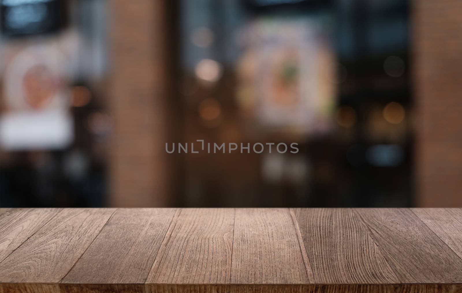 Empty dark wooden table in front of abstract blurred bokeh background of restaurant . can be used for display or montage your products.Mock up for space