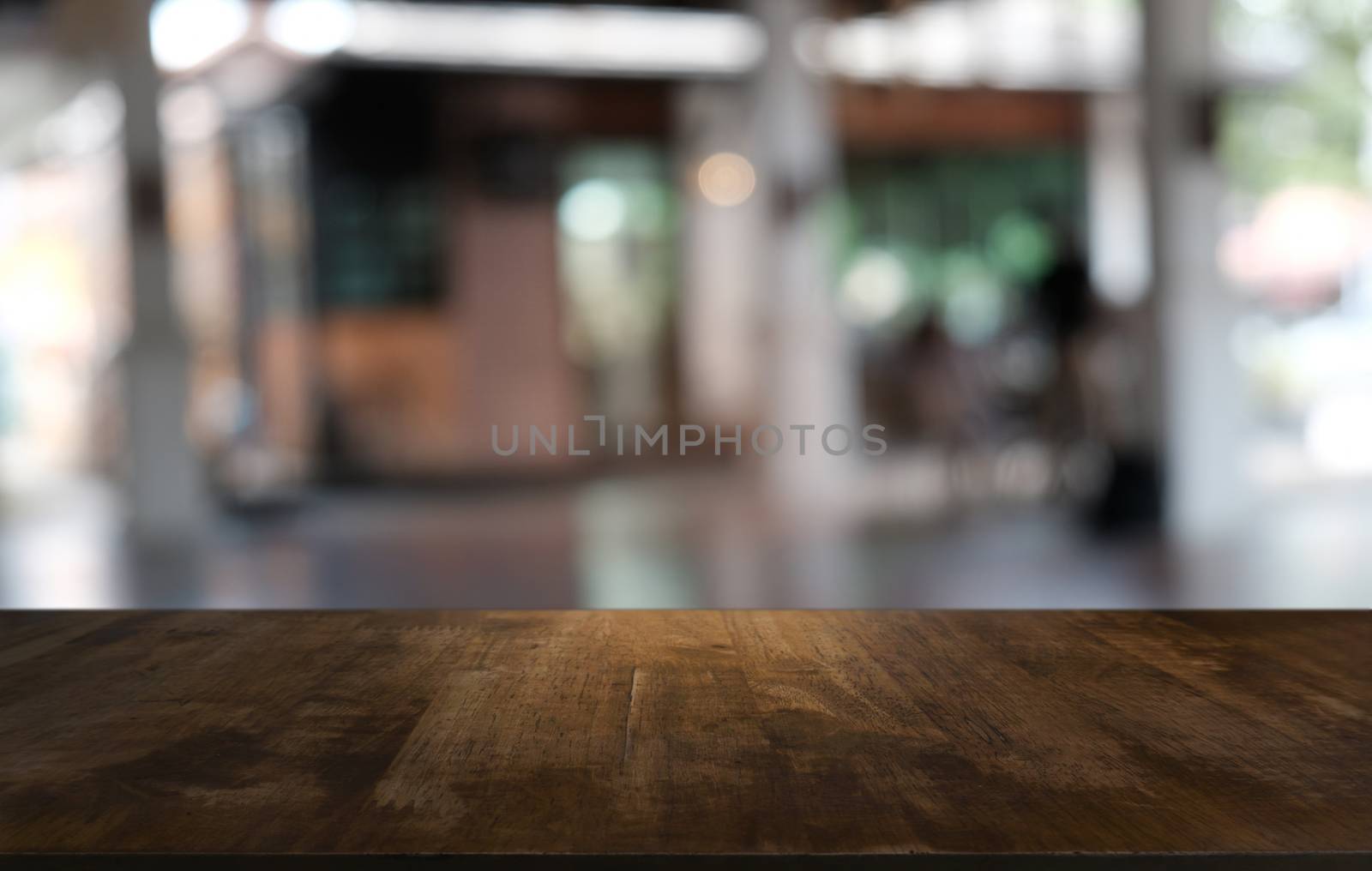 Empty dark wooden table in front of abstract blurred bokeh backg by peandben