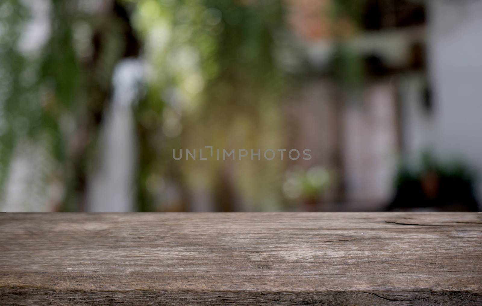 Empty dark wooden table in front of abstract blurred bokeh backg by peandben