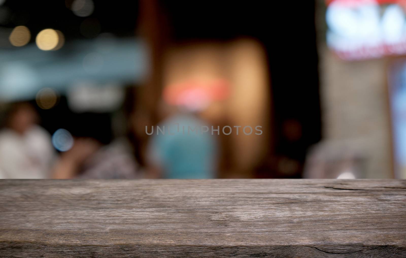 Empty dark wooden table in front of abstract blurred bokeh background of restaurant . can be used for display or montage your products.Mock up for space