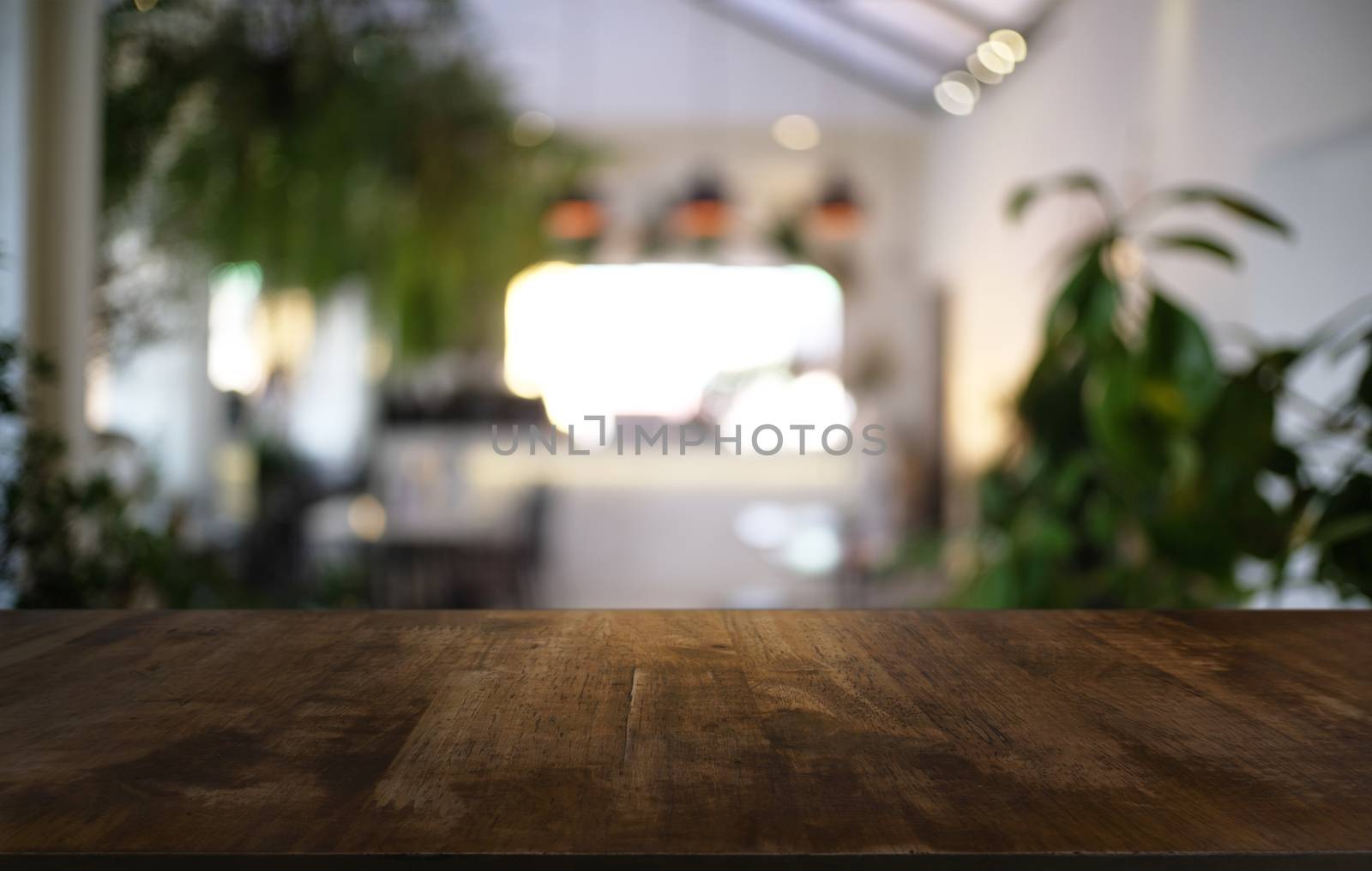 Empty dark wooden table in front of abstract blurred bokeh backg by peandben