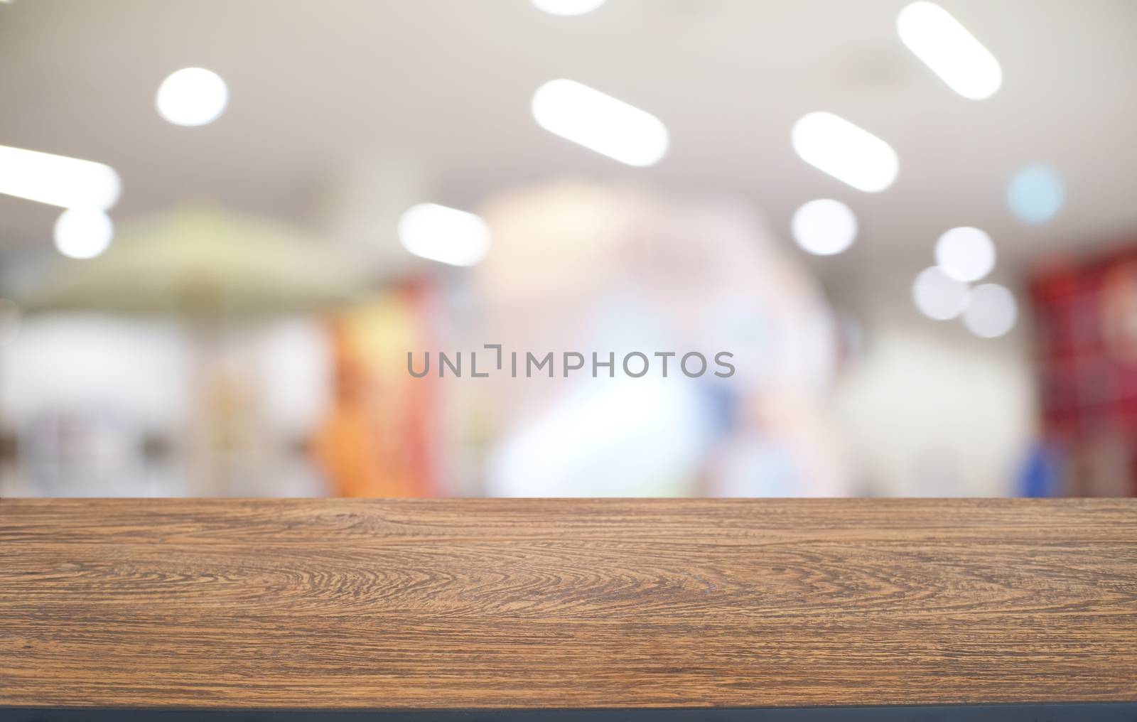 Empty dark wooden table in front of abstract blurred bokeh background of restaurant . can be used for display or montage your products.Mock up for space