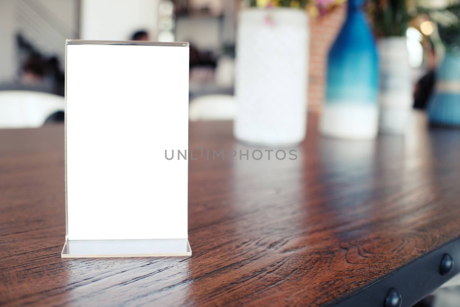 Menu frame standing on wood table in Bar restaurant cafe. space for text marketing promotion