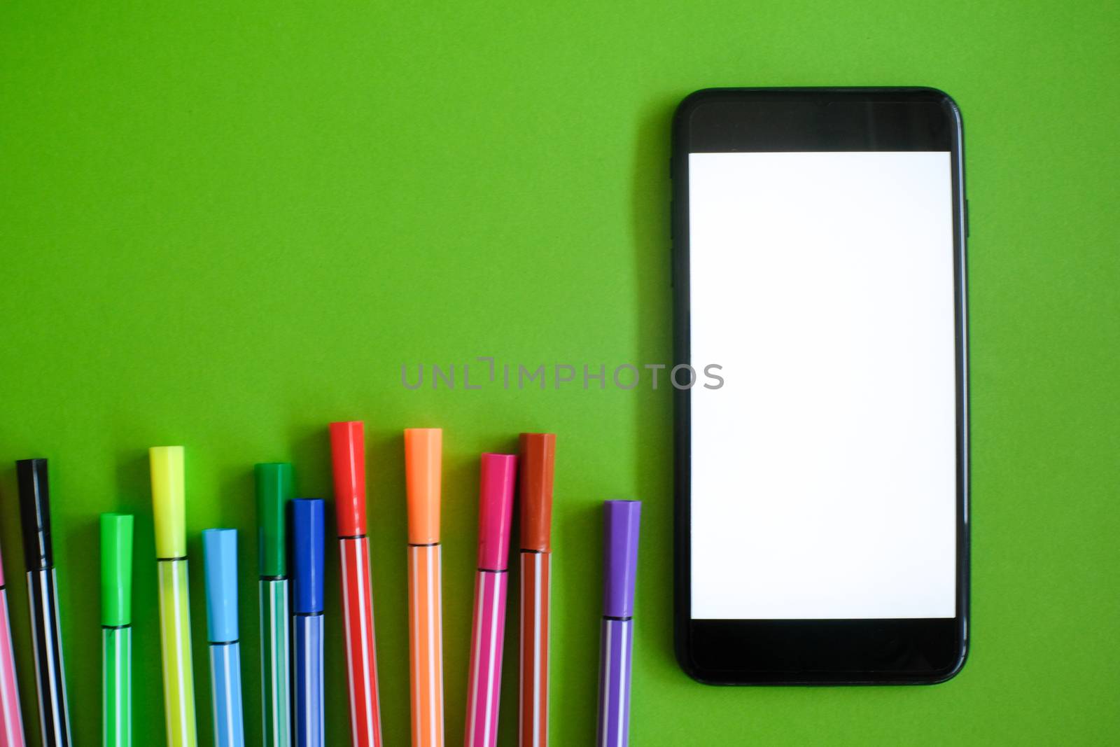 Mockup of smart phone on office desk. by peandben