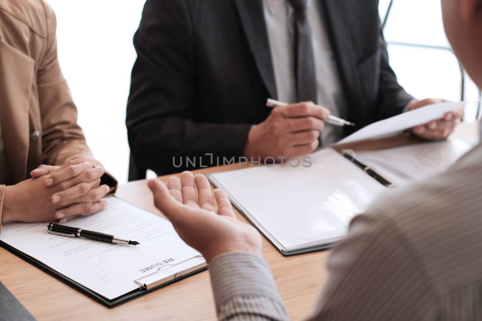 Examiner reading a resume during job interview at office Busines by peandben