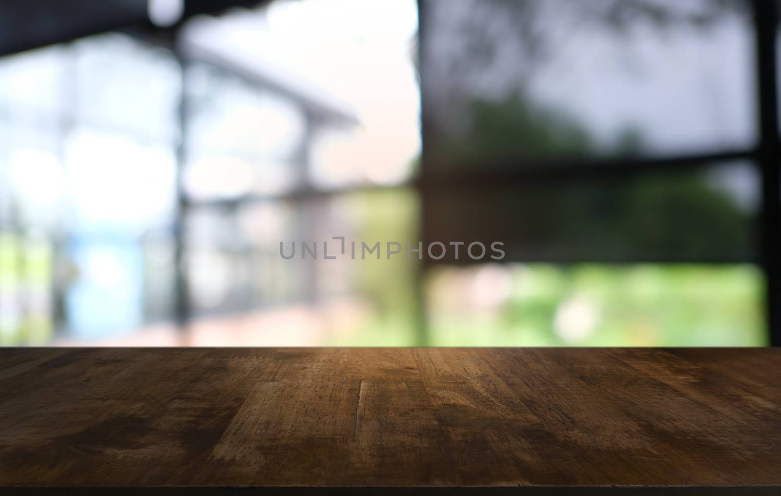 Empty dark wooden table in front of abstract blurred bokeh background of restaurant . can be used for display or montage your products.Mock up for space