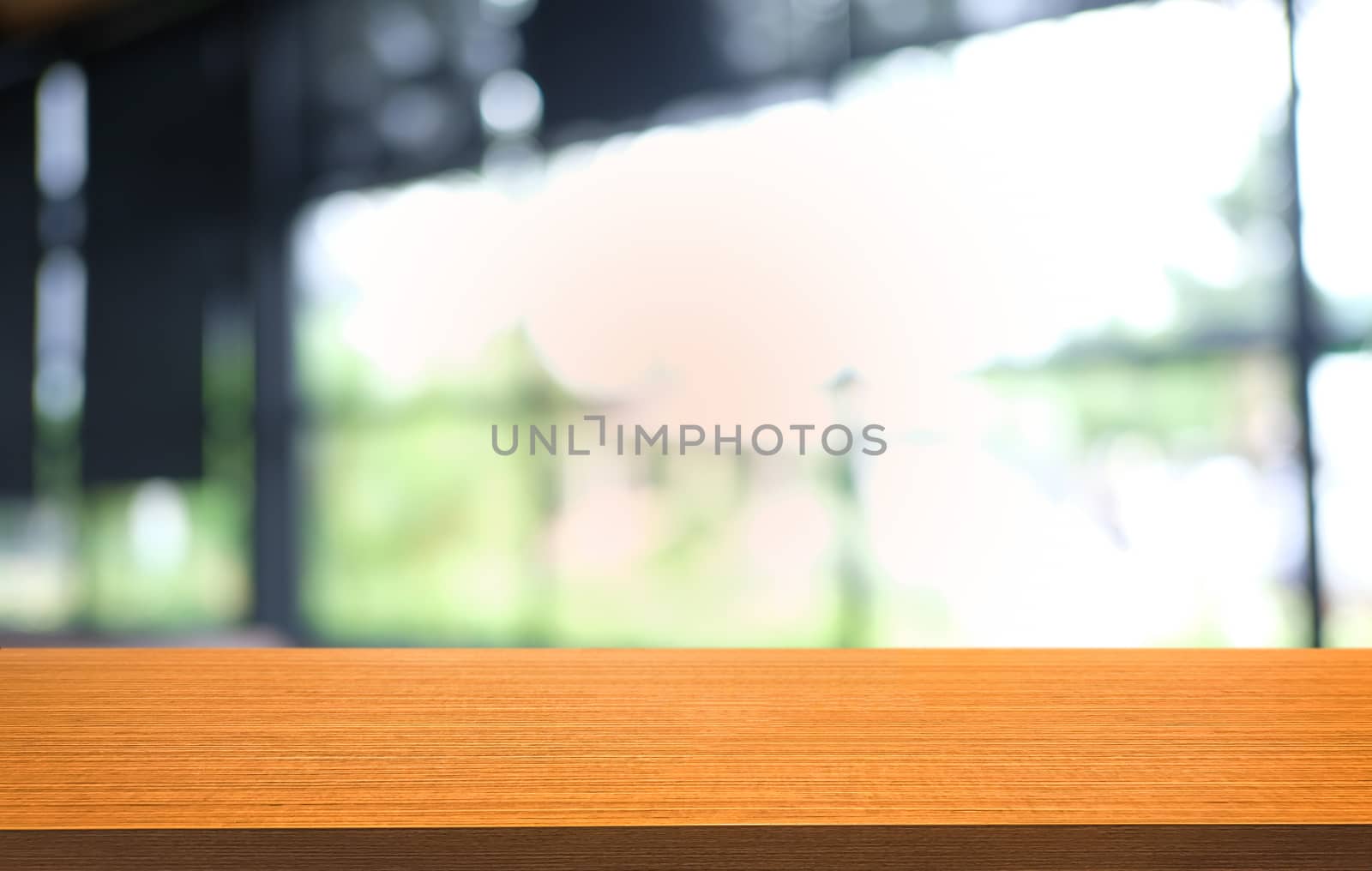 Empty dark wooden table in front of abstract blurred bokeh background of restaurant . can be used for display or montage your products.Mock up for space