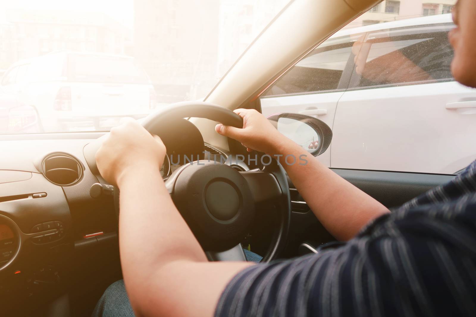 Man driving with both hands on steering wheel selective focus. s by peandben
