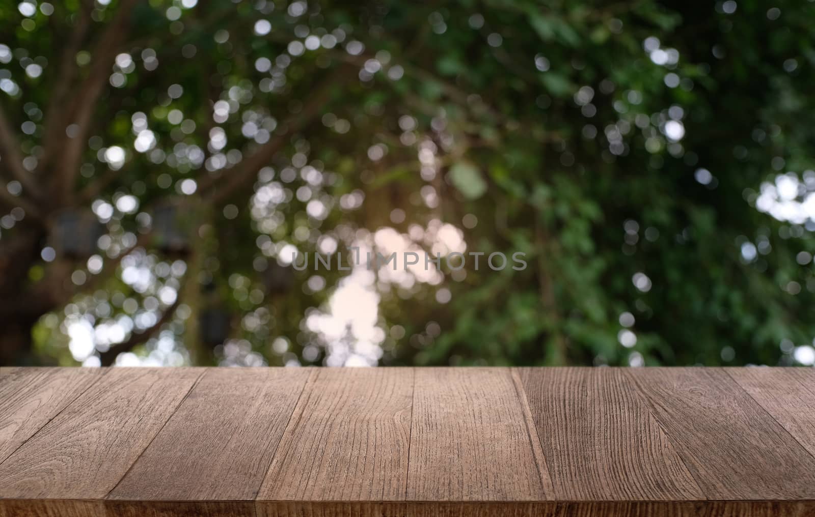 Empty dark wooden table in front of abstract blurred bokeh backg by peandben