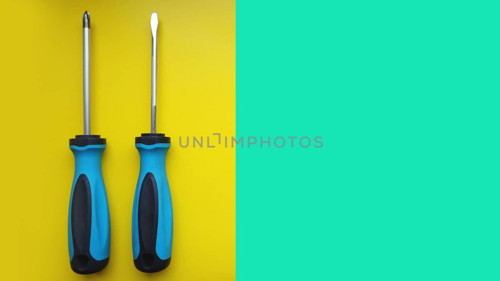 Screwdriver isolated on bright Background. Top View of Blue Handle Screwdriver Tool with Real Shadow. Space for Text or Image