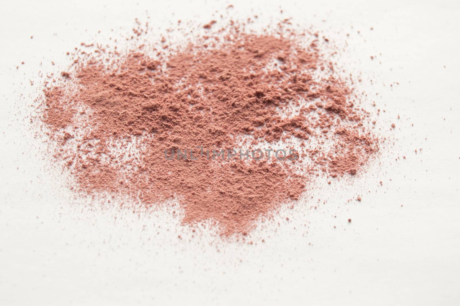 Scattered beige powder, Crumbles natural makeup powder on white background by claire_lucia