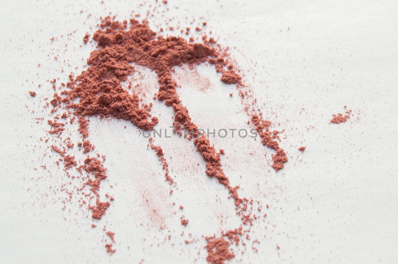 Scattered beige powder, Crumbles natural makeup powder on white background by claire_lucia