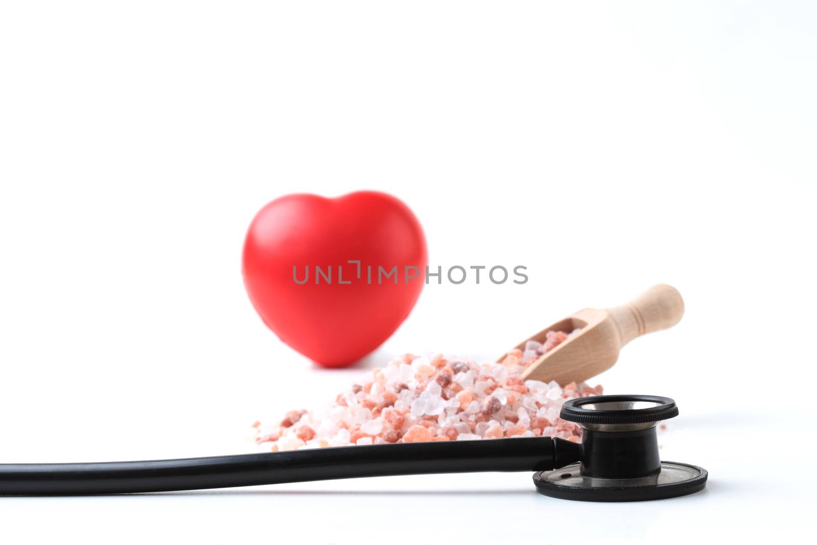 Black Stethoscope with Salt and Red Heart Isolated On White Background