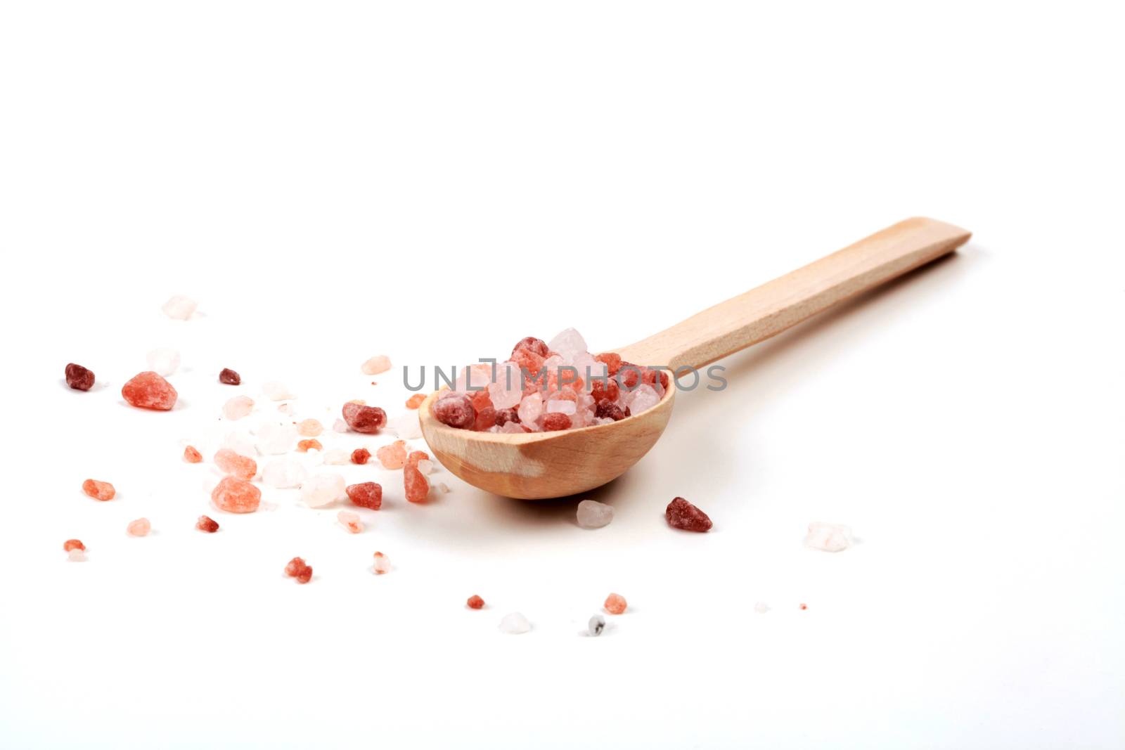 Isolated Himlalayan Salt With Brown Wood Spoon